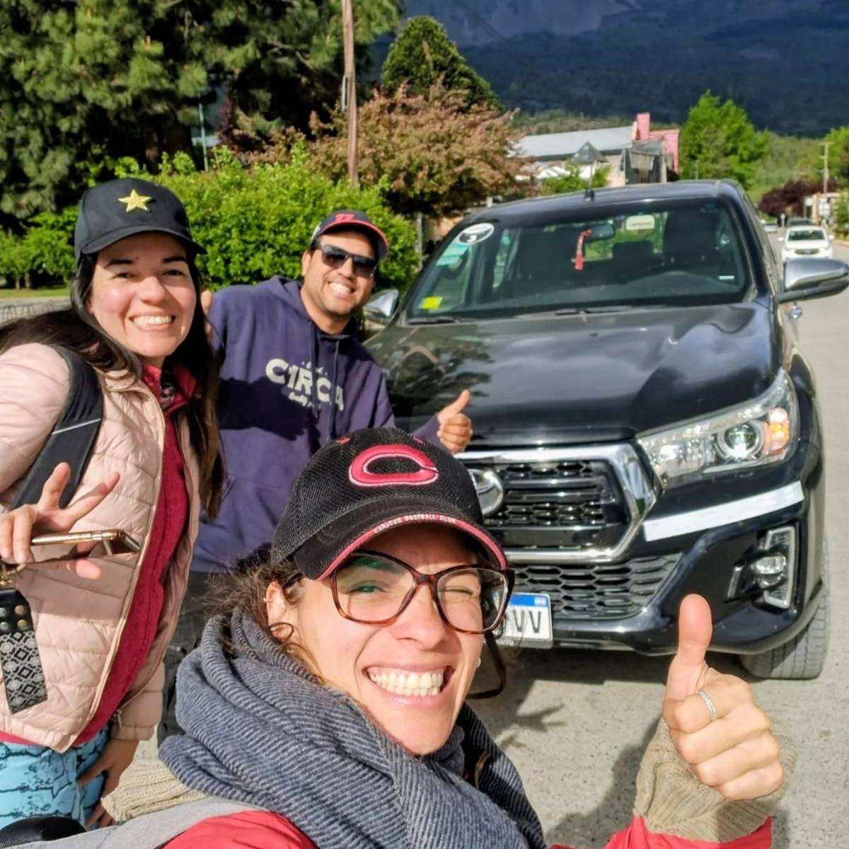 Martín con dos pasajeras junto a su Hilux